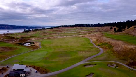 Panning-aerial-of-beautiful-golf-course-on-the-edge-of-the-water
