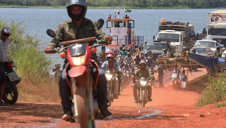 A-crowd-of-motorcyclists-exit-a-ferry-after-crossing-a-river-in-Brazil