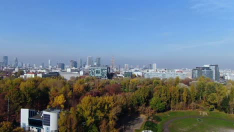Warsaw's-tourist-hotspots-such-as-Warsaw-Old-Town,-Skyline-and-palace-of-science-and-culture,-aerial-from-Stadion-Politechniki-Warszawskiej-Syrenka