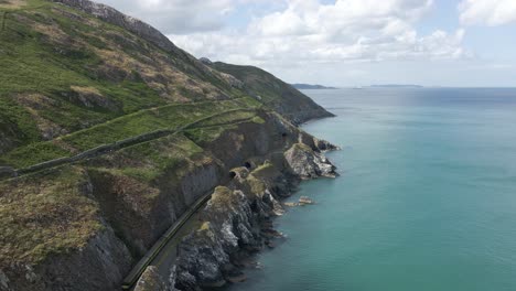Train-Passing-By-And-Exiting-A-Tunnel-With-Cliff-Walk-Bray-To-Greystones-Near-Dublin-And-Bray-Town-In-Ireland