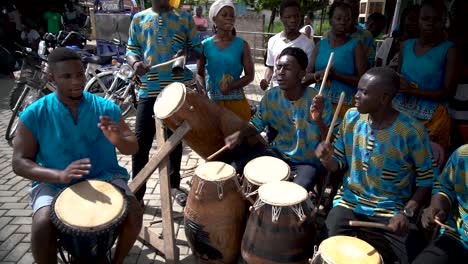 A-group-of-drummers-perform-at-the-traditional-Yam-Festival-in-rural-Ghana,-West-Africa,-captured-in-slow-motion