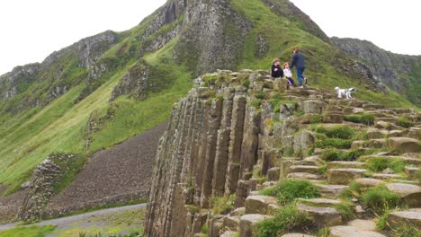 Tourists-climbing-Giant's-Causeway-Ireland-rocks