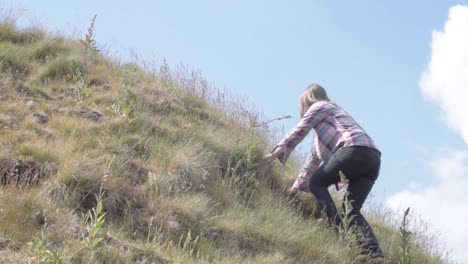 Woman-climbing-hill-in-rugged-moorland