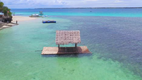 Thatched-shelter-on-floating-dock-off-beach-in-the-Philippines