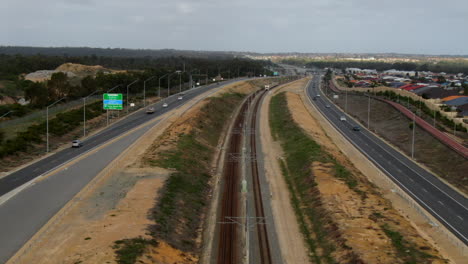 Aerial-of-Train-driving-on-Joondalup-Butler-line-between-Clarkson-and-Butler-Station-in-Perth-Western-Australia