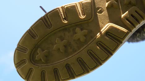 Sole-of-boot-coming-down-towards-camera-close-up-shot