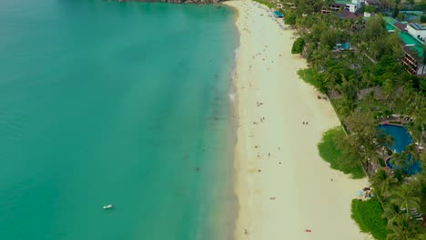 Aerial-panorama-of-tropical-resort-territory-and-beach,-beautiful-Andaman-sea-at-west-coast-of-Phuket-Island