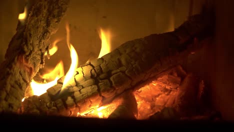 Burning-log-of-wood-close-up-as-abstract-background