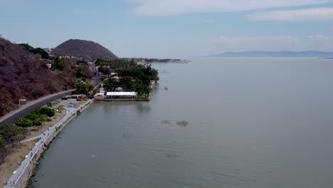 Rising-aerial-drone-footage-above-Lake-Chapala-and-Chapala-town-in-Jalisco,-Mexico