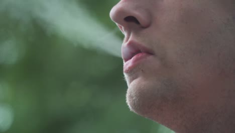 Close-Up-of-Male-Model-Smoking-Vaporizer-Outside-60fps