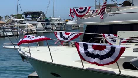 Red,-white,-and-blue-patriotic-decor-on-private-yachts-docked-along-the-harbor-at-San-Diego's-Seaport-Village