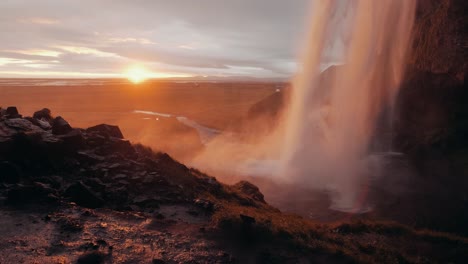 Slow-motion-shot-of-Seljalandsfoss-at-sunset,-a-famous-waterfall-in-Iceland