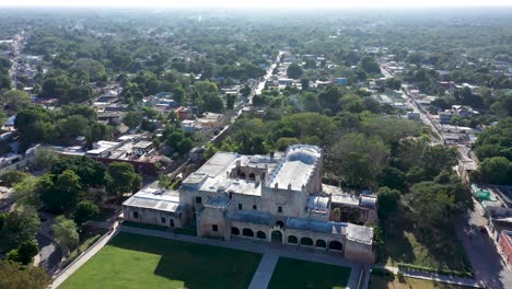 Aerial-orbit-to-the-left-centered-on-the-Convent-de-San-Bernardino-in-Valladolid,-Yucatan,-Mexico-in-early-morning