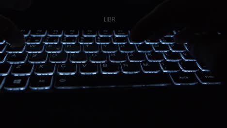 Closeup-of-male-hands-typing-LIBRA-on-a-backlit-notebook-keyboard-to-do-research-on-the-decentralized-cryptocurrency-to-be-launched-by-Facebook-to-bank-the-unbanked:-Text-appears-while-typing