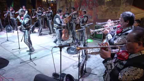 Wide-angle-shot-of-Mariachi-band-on-stage-outside-at-night-during-Merida-Fest-in-Merida,-Mexico