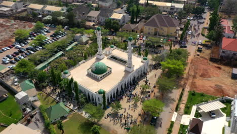 Hundreds-of-people-exit-the-Mosque-after-Friday-prayers---orbiting-aerial-view