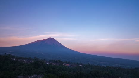 Setting-sun-lights-op-Mount-Merapi-with-soft-falling-evening-orange-light,-Java