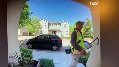 Nest-cam-footage-of-a-man-wearing-a-PG-E-uniform-ringing-the-doorbell-of-a-residential-house