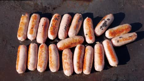 Pork-sausages-cooking-on-an-open-fire-barbecue