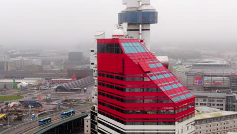 Aerial-arc-shot-of-The-Lipstick-building-in-Gothenburg,-Sweden