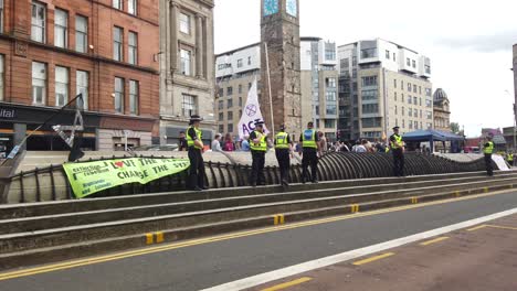 The-police-surrounded-by-banners-on-a-blocked-main-road