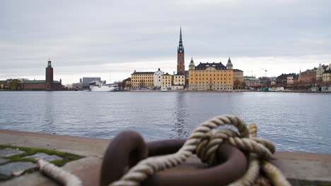 Stockholm-cityscape-with-the-canal-in-the-foreground,-dolly-shot