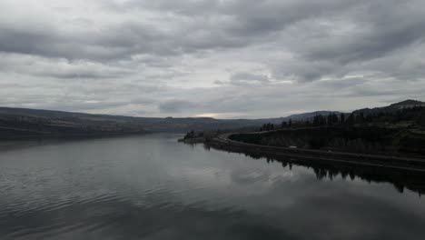 Dark-storm-clouds-reflect-off-the-rippled-Columbia-River-waters,-aerial