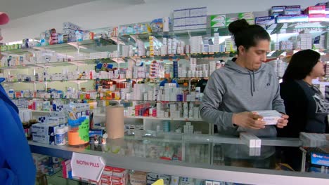 Pan-of-woman-shopping-in-small-pharmacy-in-Mexican-border-town---Algodones-Mexico