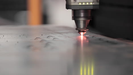 Close-Up-Of-Tip-Of-Laser-Cutter-Cutting-Stainless-Sheet-With-Sparks