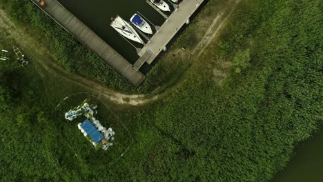 Aerial-top-down-over-marina-with-boats-moored-at-jetty
