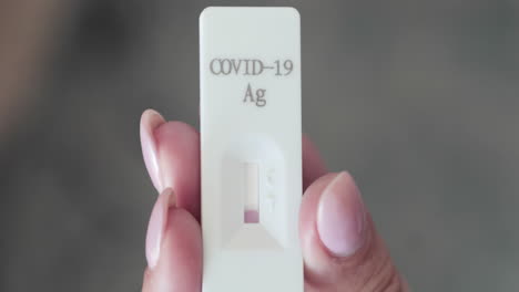 Holding-Rapid-Swab-Test-Kit-And-Waiting-For-Result-For-COVID-19-Detection