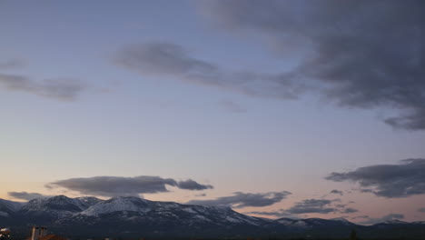 Time-lapse-of-Parnitha-mountain,-Greece-during-golden-hour-with-snow-on-top-of-the-mountain