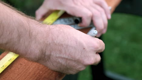 Measuring-and-Marking,-Male-Hands-in-Slow-Motion-Taking-Measurements-on-Woodworking-Project
