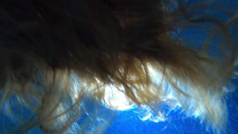 Woman-hair-under-water-in-pool