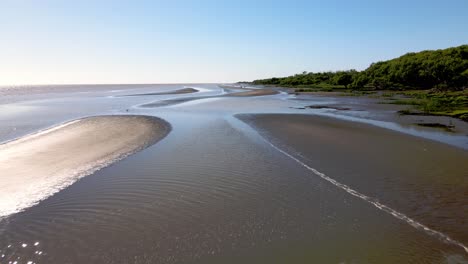 Forward-aerial-of-shallow-water-and-sandbanks-by-Rio-de-la-Plata-shore