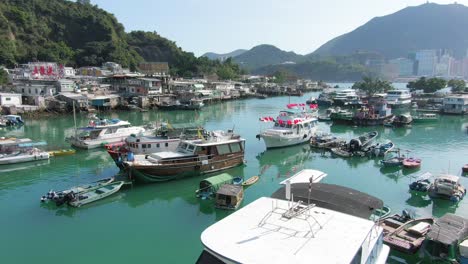 Low-pass-aerial-footage-of-Hong-Kong-Lei-Yue-Mun-fisherman-and-Seafood-restaurants-village-and-small-boat-marina