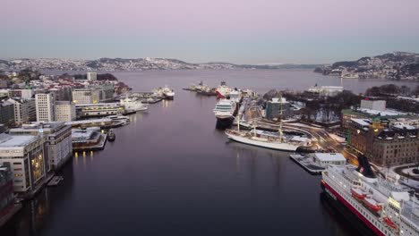 Aerial-shot-through-Bergen-harbour-first-morning-light-with-many-ships-moored-alongside