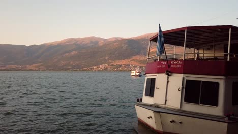 No-people---passenger-boat-with-Greek-flag-on-lake-in-the-afternoon---establisher