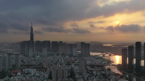 Dramatic-sunrise-drone-shot-of-Ho-Chi-Minh-City-panning-from-left-to-right-starting-with-Landmark-and-Central-Park-Developments-and-ending-with-the-Golden-River-development