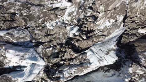Aerial-topdown-view-of-dirty-glacier-crancks-in-the-Swiss-alps