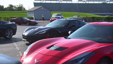 Overview-from-a-red-C7-corvette-as-others-assemble-and-park