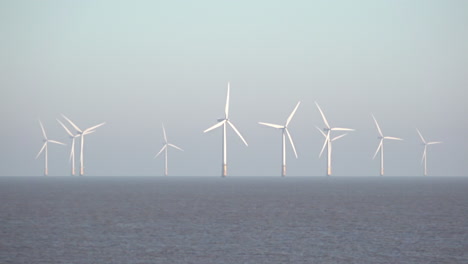 The-turbine-blades-spin-at-the-huge-Lincs-wind-farm,-that-lies-eight-kilometres-offshore-in-the-North-Sea-off-the-East-Coast-of-England