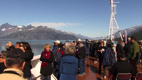 Cruising-in-Alaska-in-summer,-passengers-on-the-bow-of-the-ship