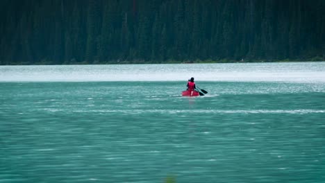 A-cute-couple-canoeing-on-a-peaceful-lake