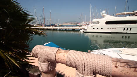 sliding-shot-overlooking-a-sunny-luxury-marina-with-several-boats-and-yachts