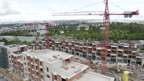 Construction-of-new-apartment-blocks,cranes-and-material,city-skyline