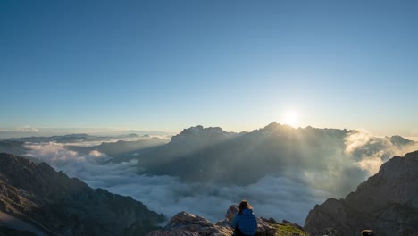 Excursionista-Observa-La-Majestuosa-Puesta-De-Sol-Con-Nubes-Bajas-En-El-Refugio-De-Collado-Jermoso-En-Picos-De-Europa,-Leon,-España