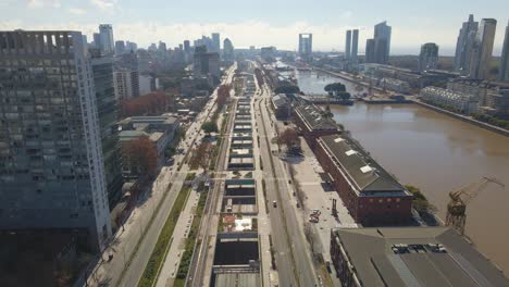 Aerial-flying-over-Paseo-del-Bajo-highway-in-Buenos-Aires's-Puerto-Madero-neighborhood-with-some-traffic