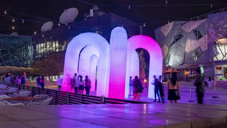 Wide-Shot-Time-Lapse-of-Sky-Castle-Inflatable-Interactive-LED-Light-rainbow-arches-by-ENESS-during-Christmas-2020-at-Federation-Square-Melbourne-Victoria-Australia