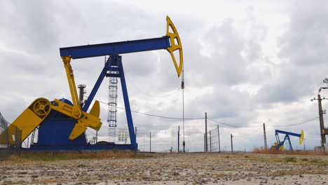 Mechanical-oil-well-pumpjacks-at-an-oil-field-near-Ploiesti,-Romania